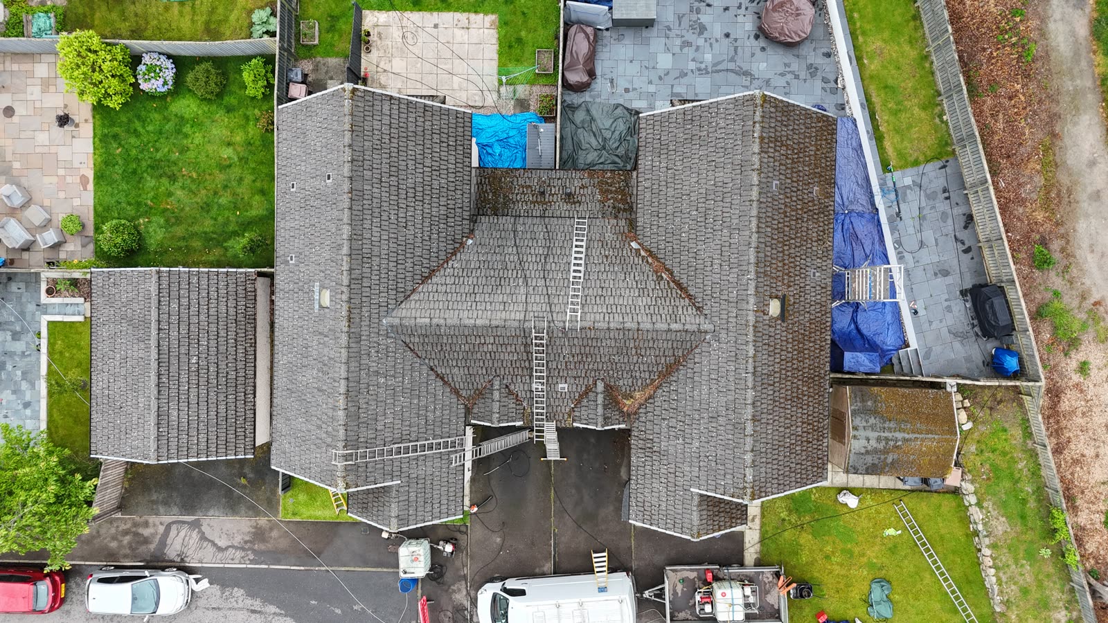 The same roof before cleaning, dark with moss